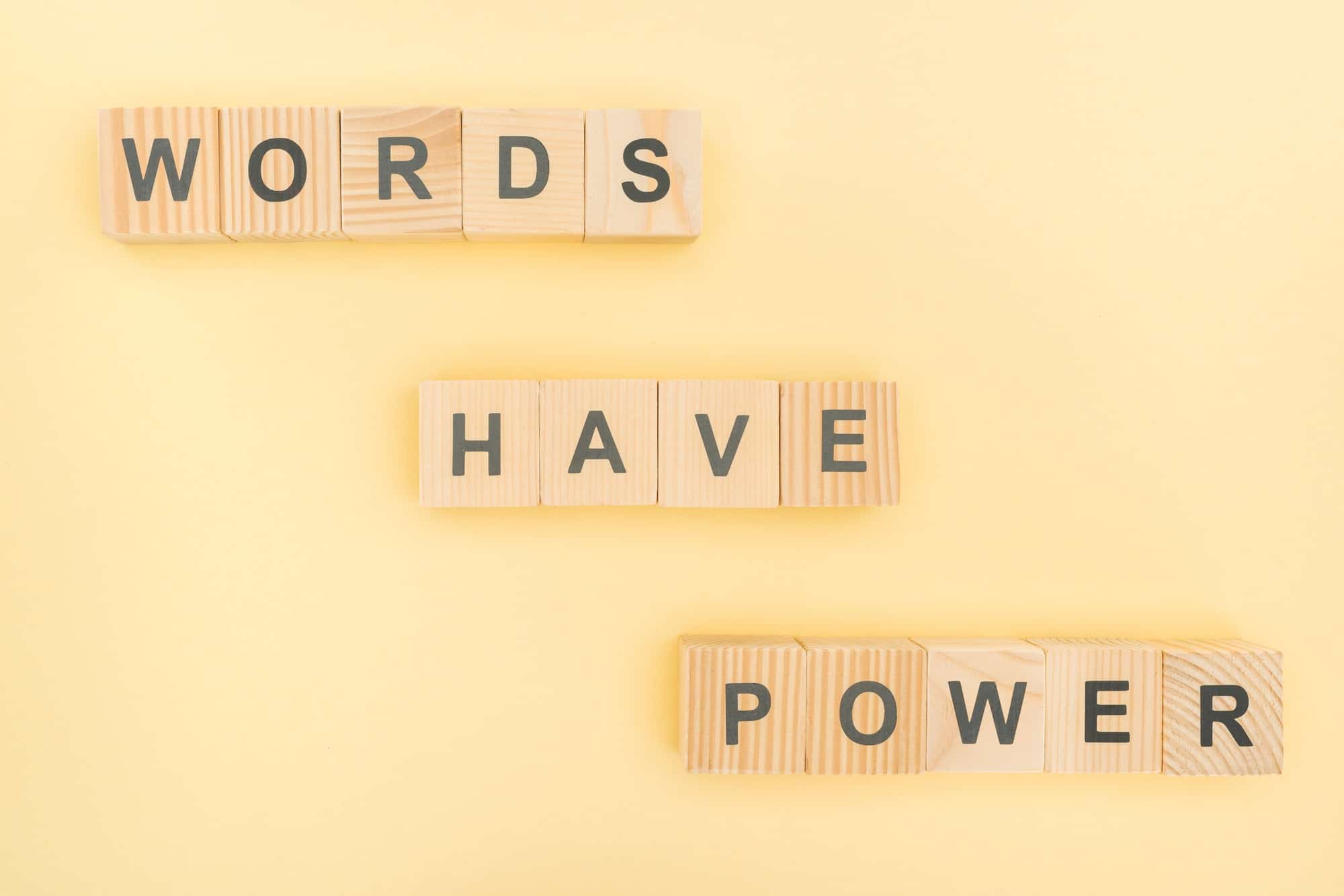 top view of phrase words have power lettering with wooden cubes on yellow background